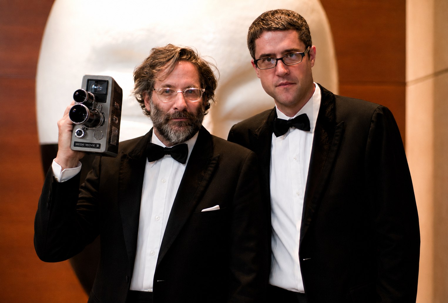 Douglas Gayeton and Reuben Steiger in tuxedos, 2007, Gayeton holding a Mega-Movie II camera